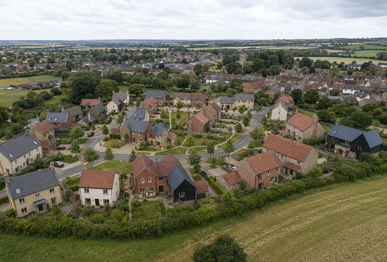 AI-generated aerial visual of a village-edge residential scheme